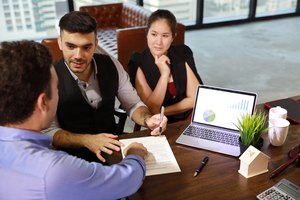 businessman and businesswoman going to sign business project contract during meeting