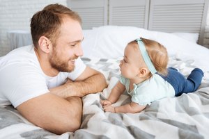 Amazed toddler girl having fun with her father