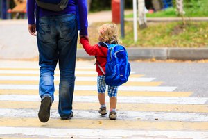 father with little daughter walking to school or daycare