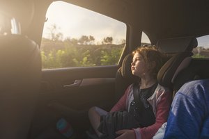 Young girl looking out of car window