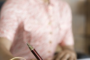 Businesswoman writing at desk