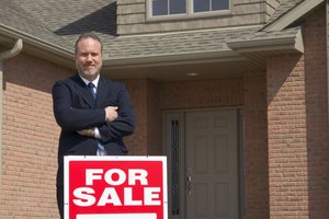 Businessman with For Sale sign