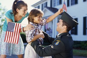 Side view of a young man wearing a military uniform holding a boy