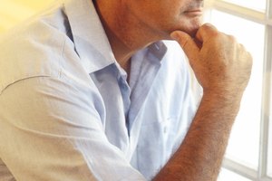 Serious man thinking by window