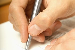 Person signing contract, close-up, selective focus