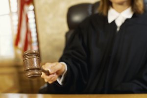 Close-up of a judge hitting the gavel against the sound block