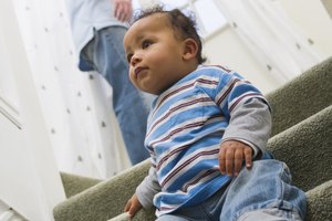 Child sitting on steps while father is distracted