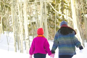 Mother and daughter walking in woods