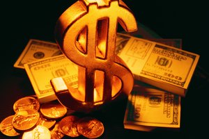 Dollar sign on top of coins and bundles of dollar bills