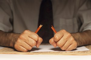 Stressed man breaking pencil, (Mid section)