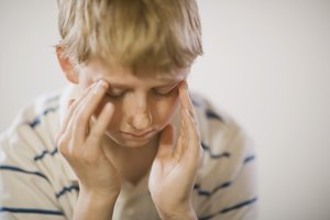 Boy with hands on head