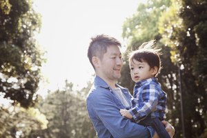 Father carrying his son in the park